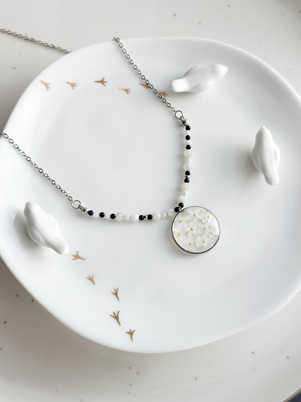 naszyjnik z niezapominajkami, naszyjnik handmade, srebrny naszyjnik z żywicy, biżuteria z prawdziwych kwiatów, naszyjnik z noc kairu, naszyjnik z kamieniem księżycowym, naszyjnik okrągły, ręcznie robiony naszyjnik, amulet ochronny, naszyjnik harmonizujący, elegancki naszyjnik, biżuteria z natury