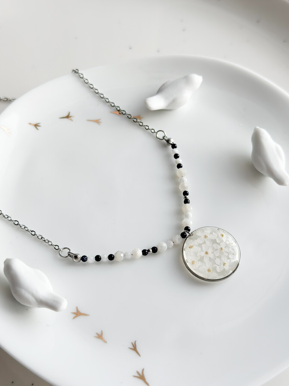 naszyjnik z niezapominajkami, naszyjnik handmade, srebrny naszyjnik z żywicy, biżuteria z prawdziwych kwiatów, naszyjnik z noc kairu, naszyjnik z kamieniem księżycowym, naszyjnik okrągły, ręcznie robiony naszyjnik, amulet ochronny, naszyjnik harmonizujący, elegancki naszyjnik, biżuteria z natury