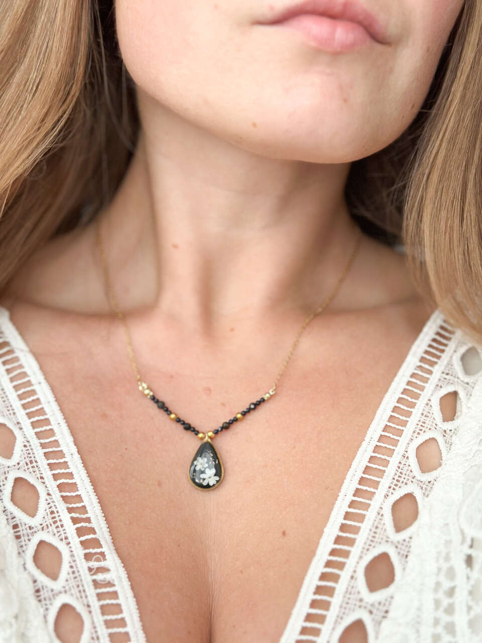 naszyjnik z niezapominajkami, naszyjnik handmade, złoty naszyjnik z żywicy, biżuteria z prawdziwych kwiatów, naszyjnik z naturalnym kamieniem, Noc Kairu, naszyjnik z łezką, ręcznie robiony naszyjnik, biżuteria ochronna, amulet z kwiatami, elegancki naszyjnik, naszyjnik z czarnym tłem