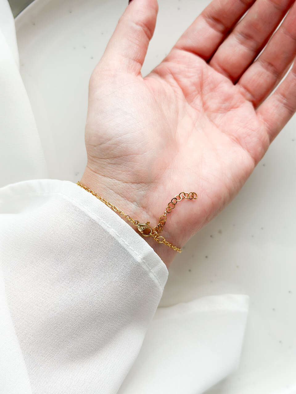 bransoletka z niezapominajką, bransoletka z sześcianem z żywicy, złota bransoletka z żywicy, biżuteria z kwiatami, bransoletka handmade, bransoletka z żywicy epoksydowej, delikatna bransoletka damska, naturalna biżuteria z kwiatów, bransoletka z niezapominajką w żywicy, prezent dla niej, biżuteria z niezapominajką